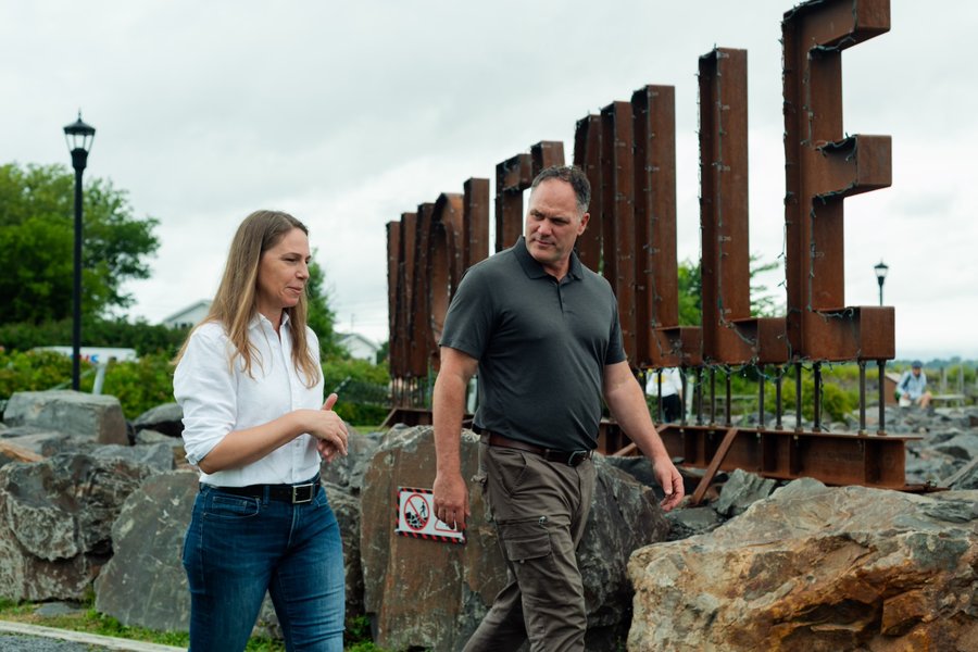 Becky Druhan walking and talking with a community member