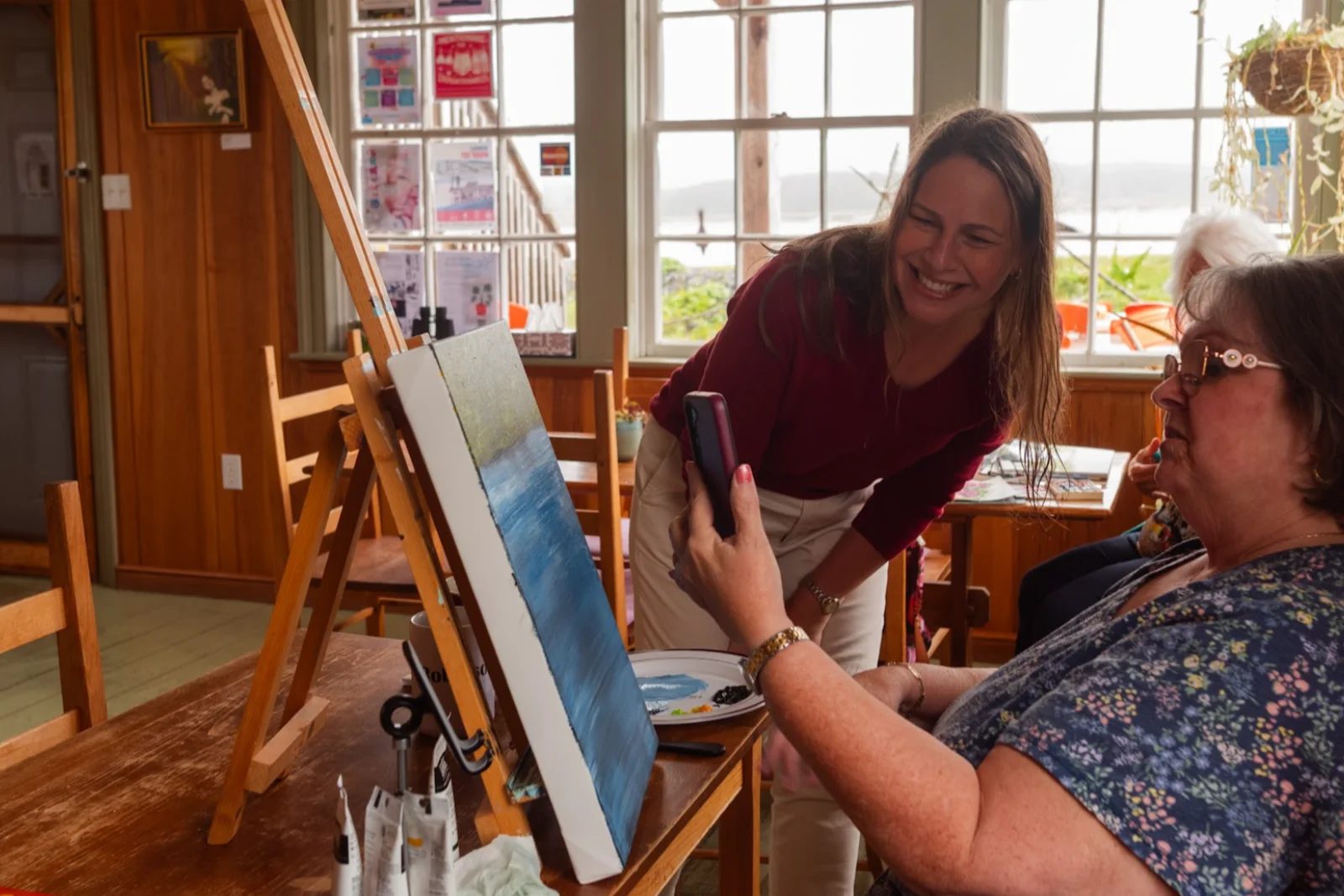Becky discussing a painting in progress with the artist in the Valley